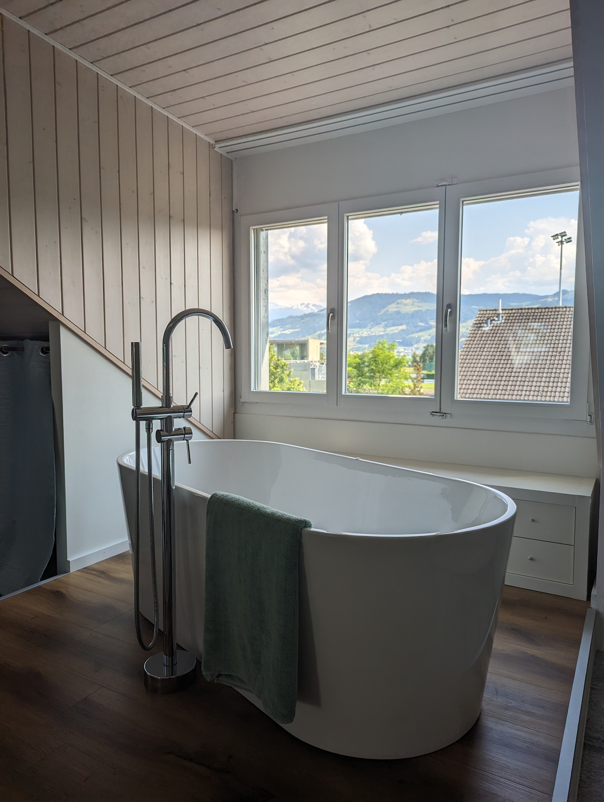 Badezimmer mit freistehender Badewanne und Bergblick